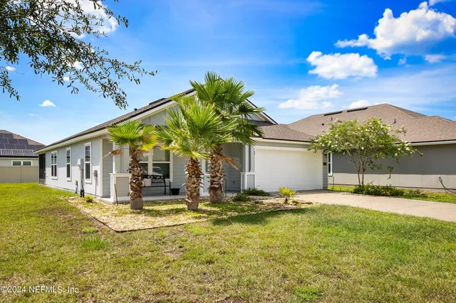 a view of a house with swimming pool and a yard