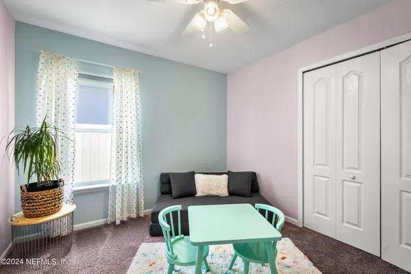 a bedroom with furniture and a window