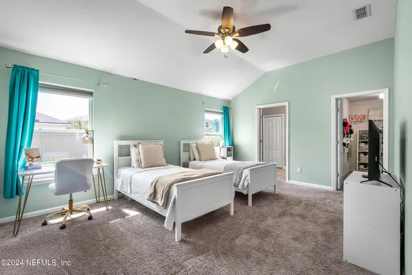 a bed room with a bed and a chair