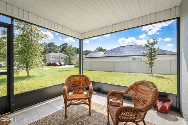 a balcony with table and chairs