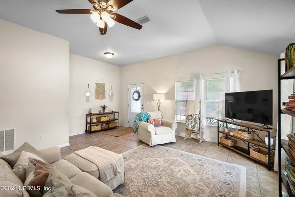 a living room with furniture and a flat screen tv