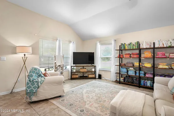 a living room with furniture and a flat screen tv