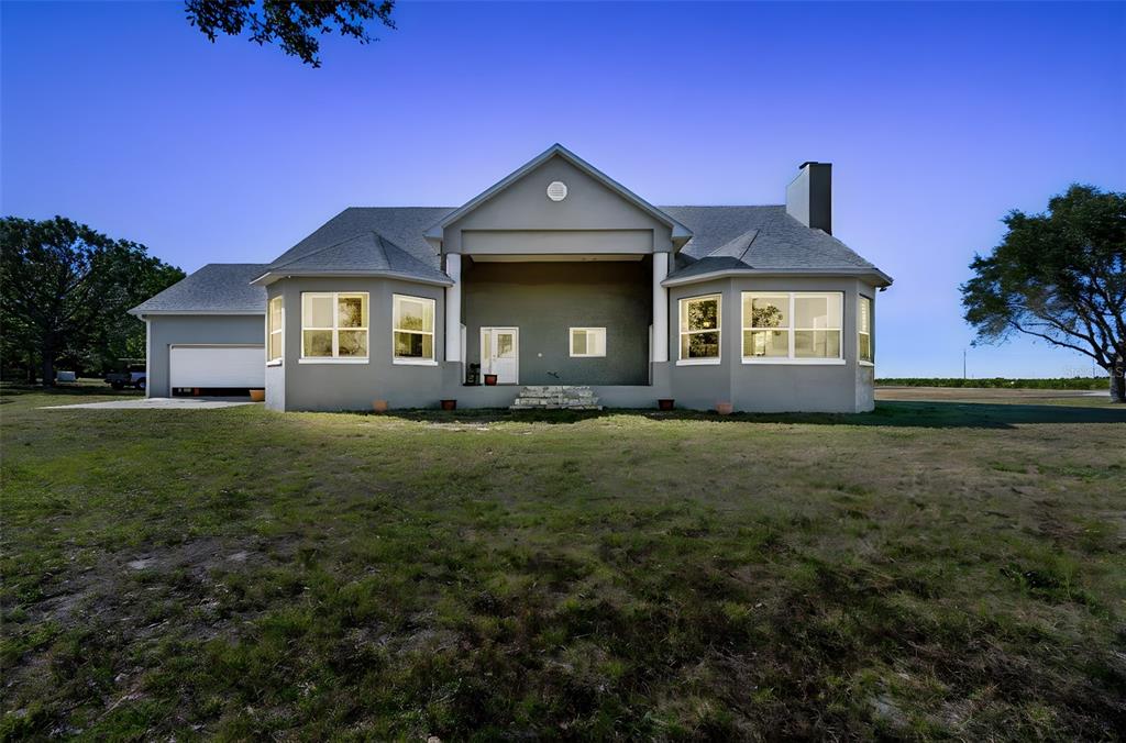 2307 Cass Road Lake Alfred, FL 33850 - Photo 1 of 67 a front view of a house with a garden