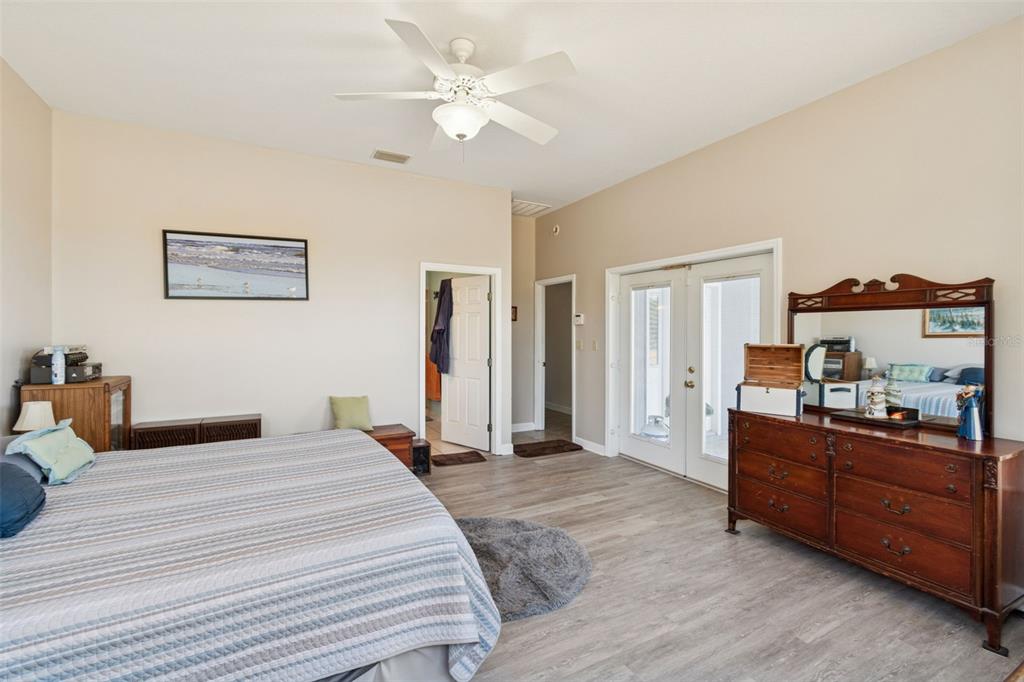 2307 Cass Road Lake Alfred, FL 33850 - Photo 20 of 67 a bedroom with a bed and a chandelier