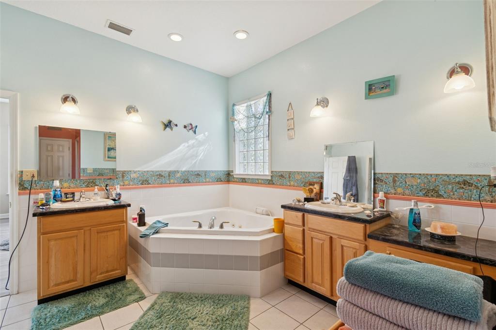 2307 Cass Road Lake Alfred, FL 33850 - Photo 23 of 67 a bathroom with a tub sink and mirror