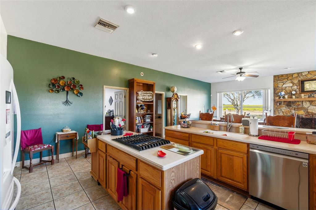 2307 Cass Road Lake Alfred, FL 33850 - Photo 32 of 67 a kitchen that has a lot of cabinets a stove and a table