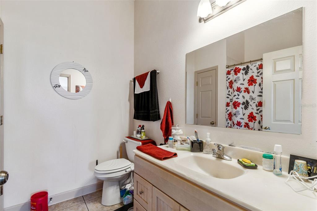 2307 Cass Road Lake Alfred, FL 33850 - Photo 34 of 67 a bathroom with a sink vanity mirror and toilet