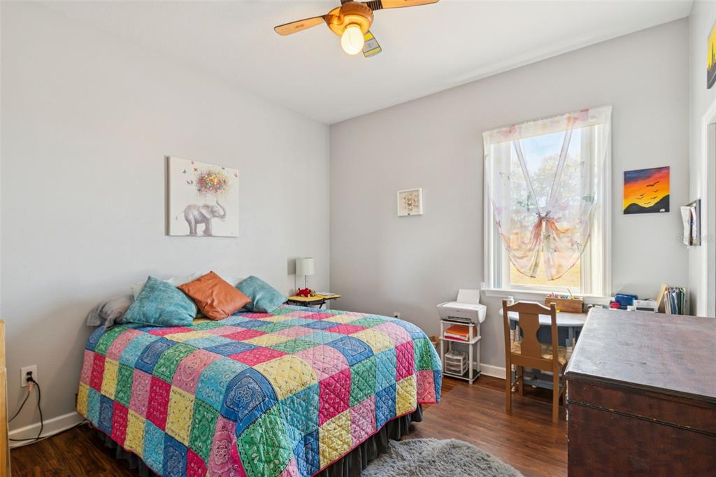 2307 Cass Road Lake Alfred, FL 33850 - Photo 38 of 67 a bedroom with a bed and a chandelier