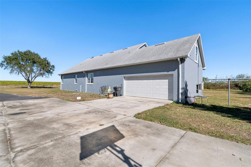 2307 Cass Road Lake Alfred, FL 33850 - Photo 49 of 67 a view of a house with a yard and a garage