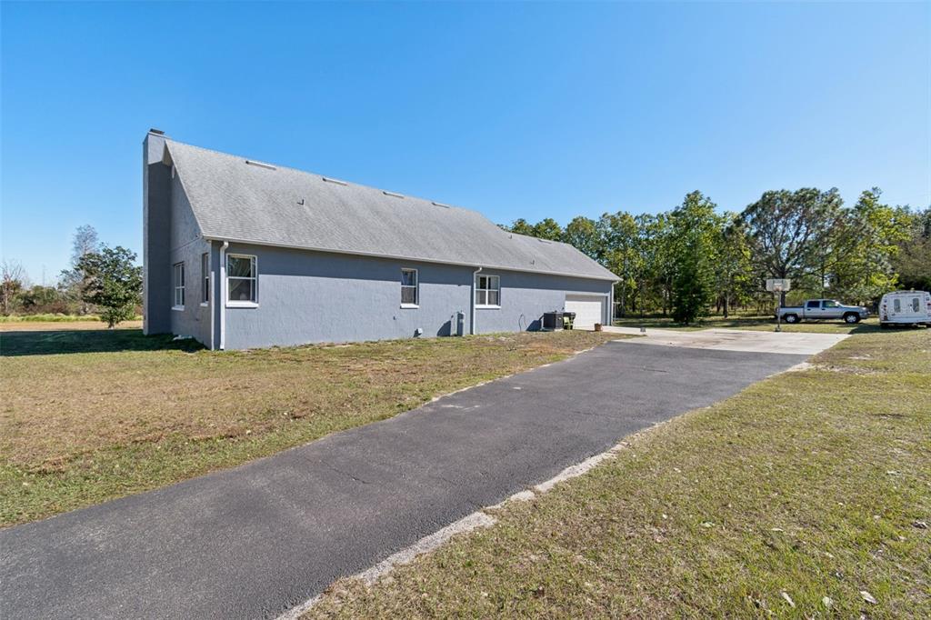2307 Cass Road Lake Alfred, FL 33850 - Photo 50 of 67 a front view of house with yard and trees in the background