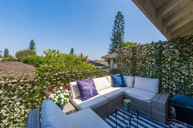 a outdoor living room with furniture and a potted plant