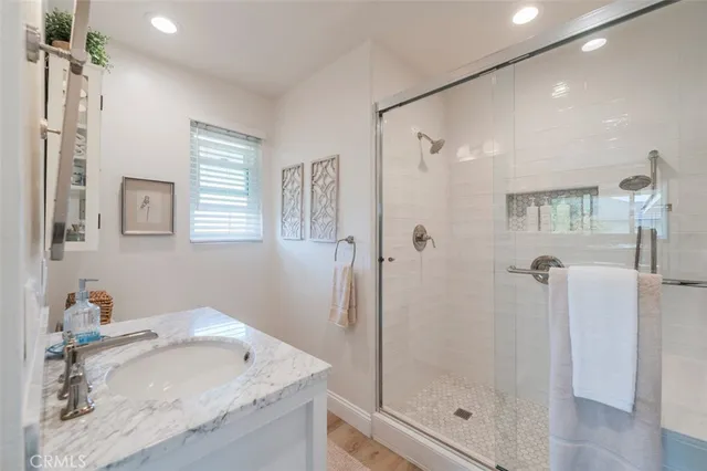 a bathroom with a granite countertop sink toilet and shower