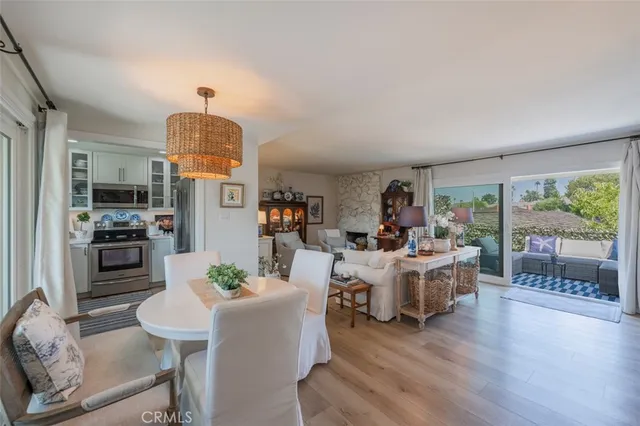 a kitchen with stainless steel appliances white cabinets and a stove top oven