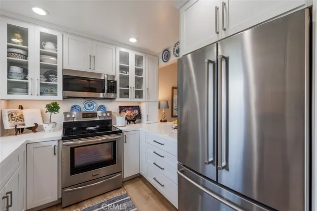 a kitchen with stainless steel appliances a refrigerator sink and stove