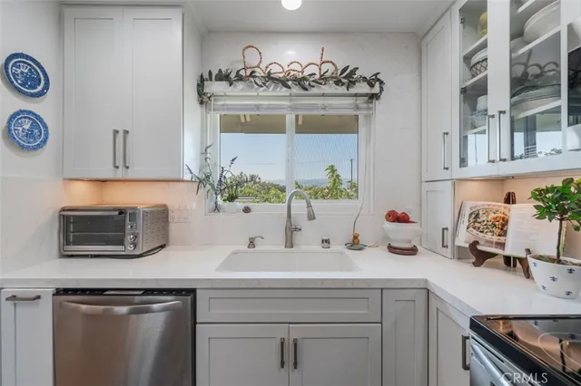 a kitchen with stainless steel appliances a stove sink microwave and cabinets