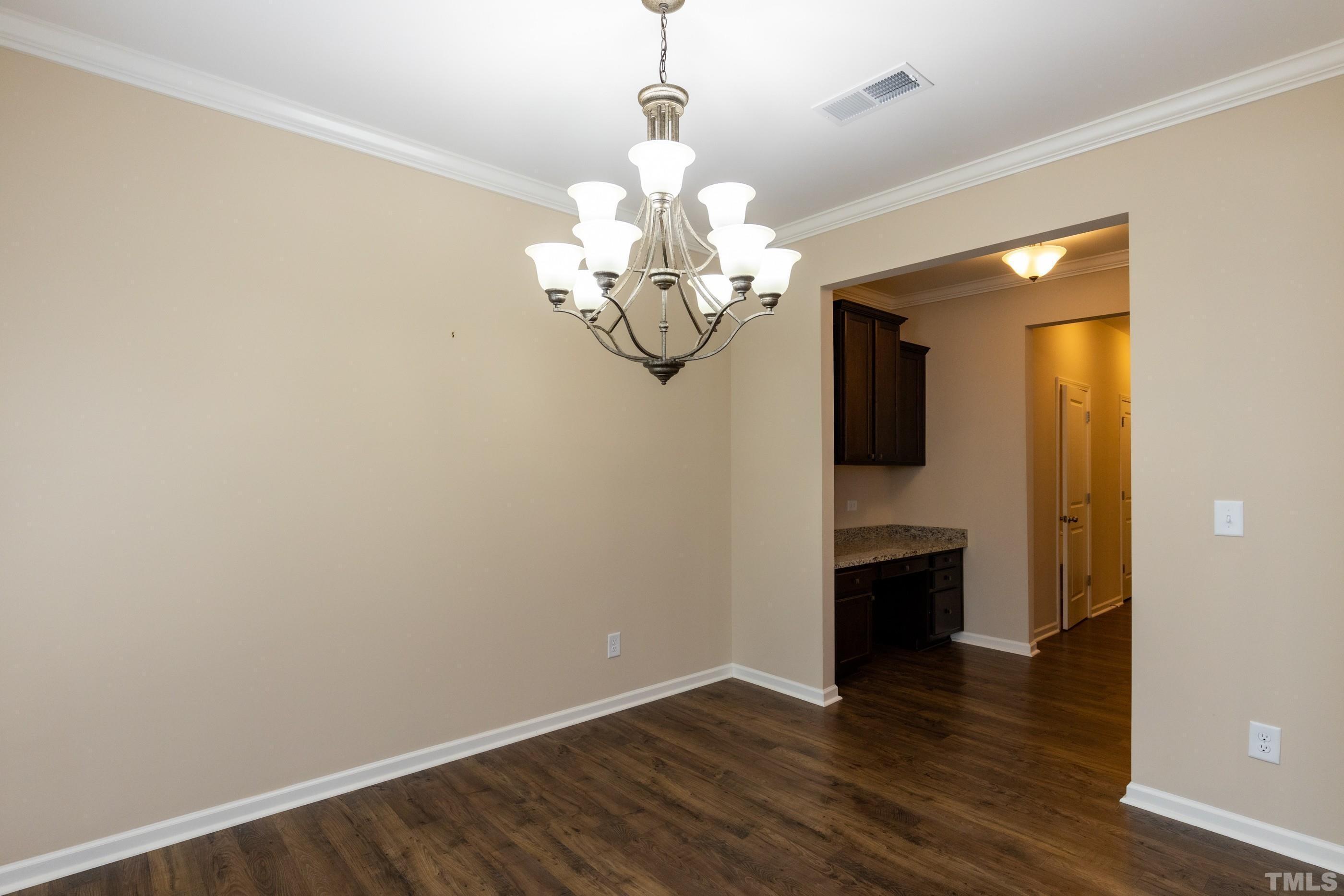 566 Chessie Station Apex, NC 27502 - Photo 11 of 29 a view of a room with wooden floor and chandelier