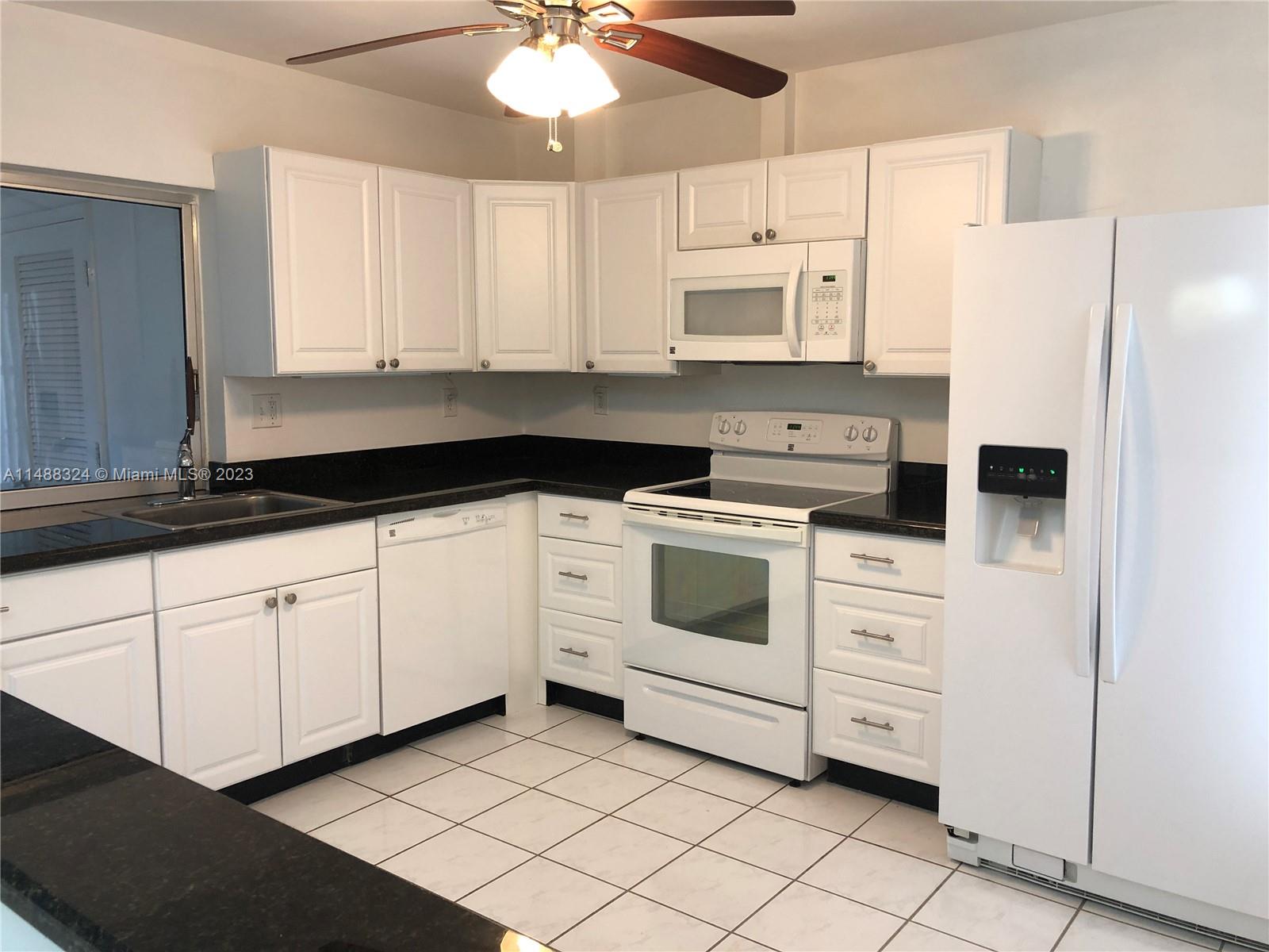 West Perrine Miami, FL 33157 - Photo 3 of 15 a kitchen with white cabinets and white appliances