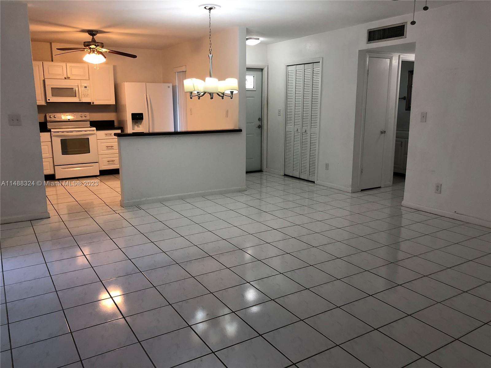 West Perrine Miami, FL 33157 - Photo 5 of 15 a view of a kitchen with kitchen island granite countertop wooden cabinets and a stove
