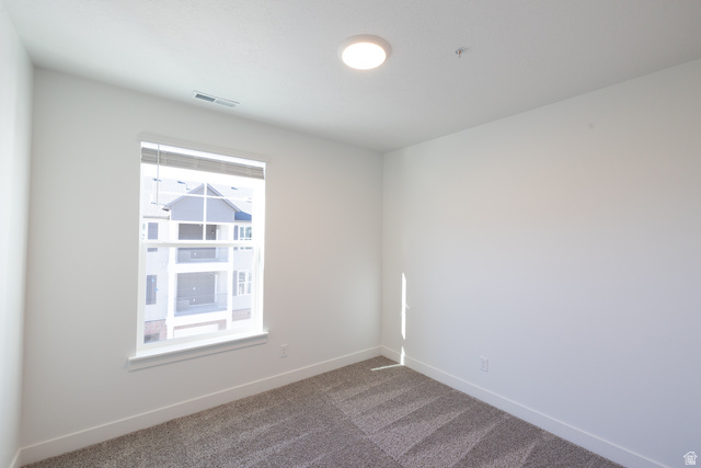 4655 South 720 West, Unit I303 Mapleton, UT 84664 - Photo 9 of 15 Spare room featuring dark colored carpet and baseboards