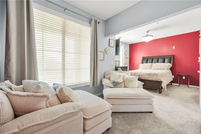 a bedroom with a bed mirror and window