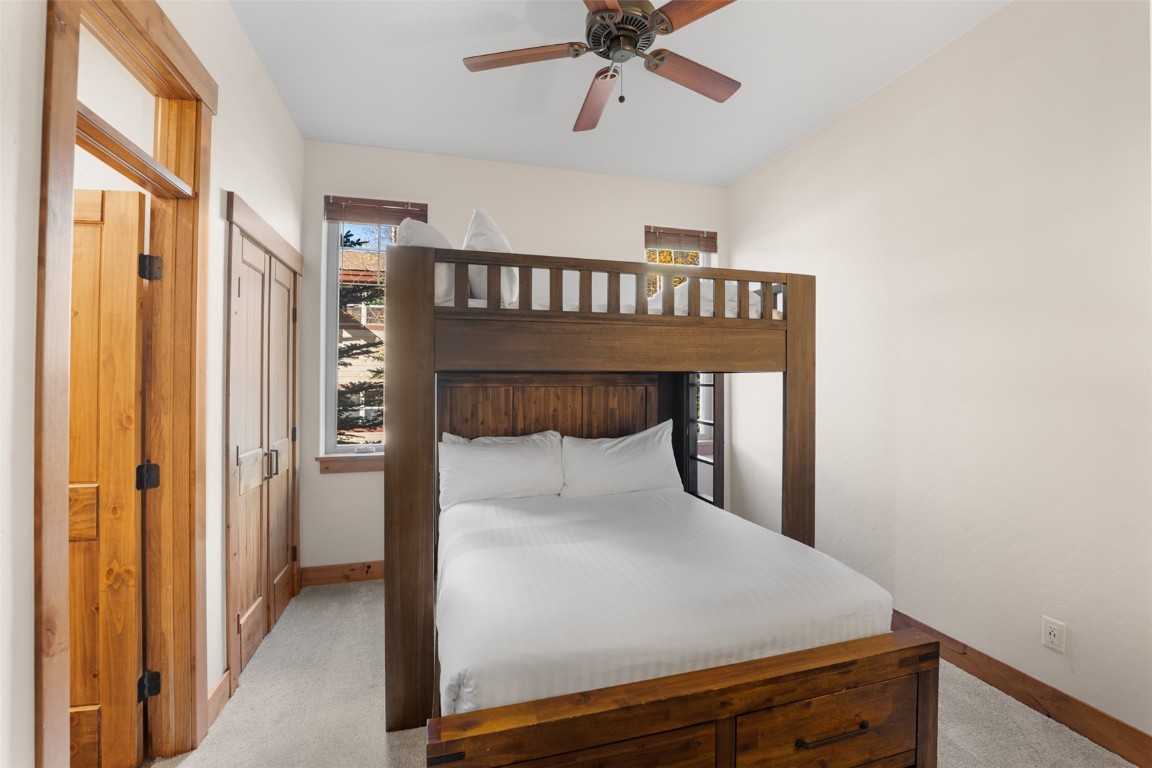 481 West Main Street, Unit 102 Frisco, CO 80443 - Photo 13 of 20 a bedroom with a bed and a chandelier