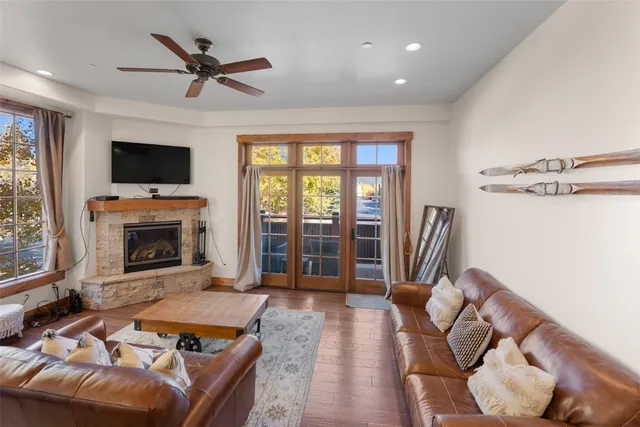 a living room with furniture a flat screen tv and a fireplace