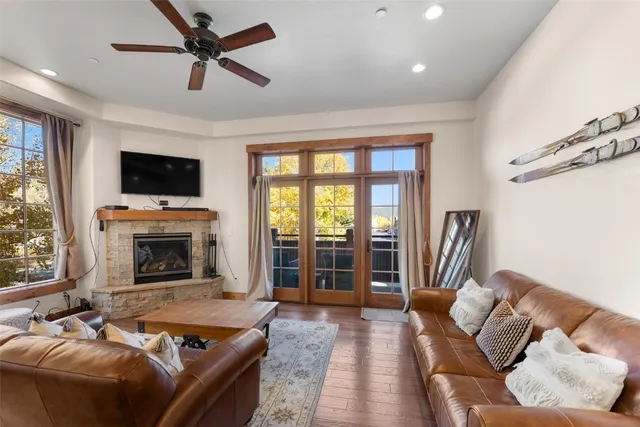 a living room with furniture a flat screen tv and a fireplace