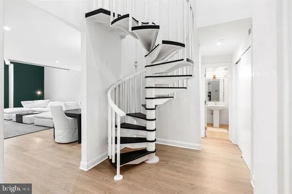 a view of entryway and hall with wooden floor