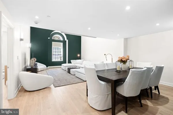 a living room with furniture and a large mirror
