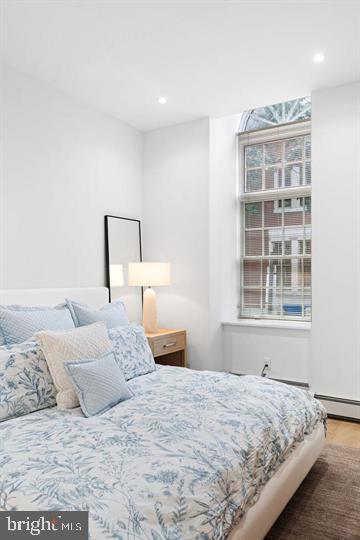 211 South 4th Street, Unit 104 Philadelphia, PA 19106 - Photo 2 of 45 a bedroom with a large bed and a window