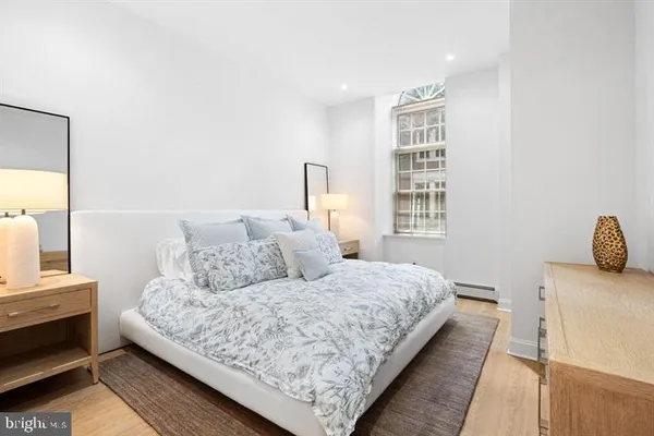 a bedroom with a bed and wooden floor