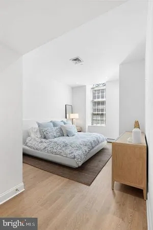 a bedroom with a bed and window