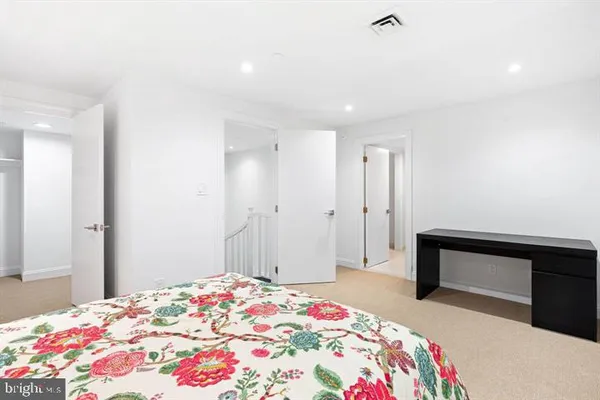 a bedroom with a bed and a dresser