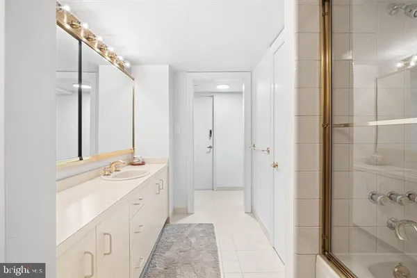 a spacious bathroom with a double vanity sink mirror and shower