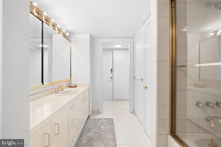 211 South 4th Street, Unit 104 Philadelphia, PA 19106 - Photo 33 of 45 a spacious bathroom with a double vanity sink mirror and shower