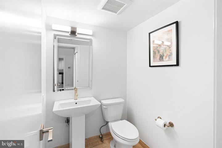 211 South 4th Street, Unit 104 Philadelphia, PA 19106 - Photo 35 of 45 a bathroom with a toilet a sink and mirror