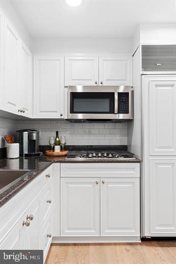 211 South 4th Street, Unit 104 Philadelphia, PA 19106 - Photo 4 of 45 a kitchen with stainless steel appliances granite countertop a stove a microwave and a white cabinets