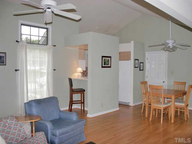 4003 Olde Coach Road Durham, NC 27707 - Photo 3 of 12 a dining room with furniture a chandelier and wooden floor