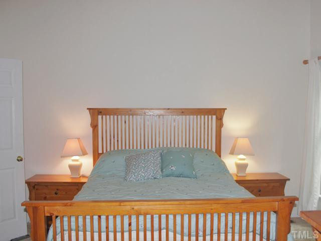 4003 Olde Coach Road Durham, NC 27707 - Photo 8 of 12 a bedroom with a bed and window