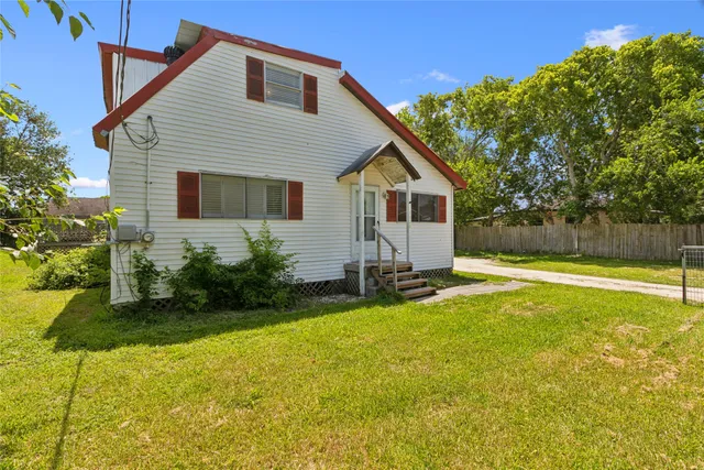 a view of a house with backyard and sitting area