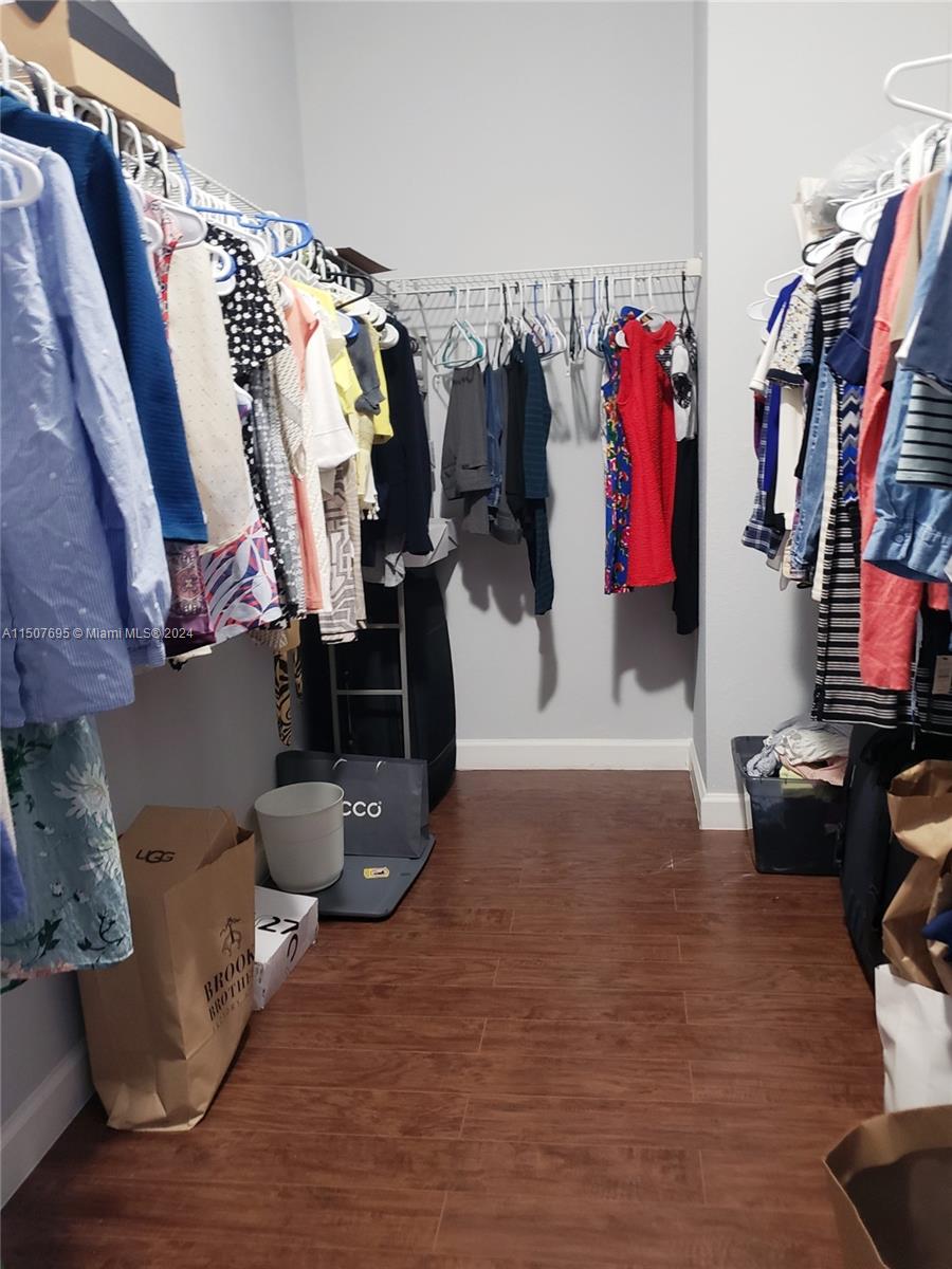 11343 Southwest 232nd Terrace Homestead, FL 33032 - Photo 17 of 35 a view of walk in closet with clothes and shoes