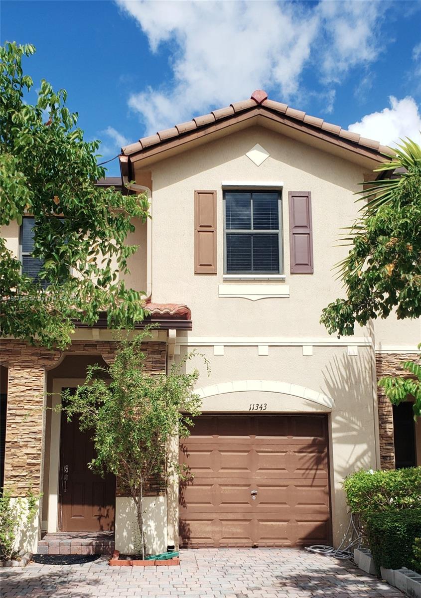 11343 Southwest 232nd Terrace Homestead, FL 33032 - Photo 2 of 35 a front view of a house with a yard