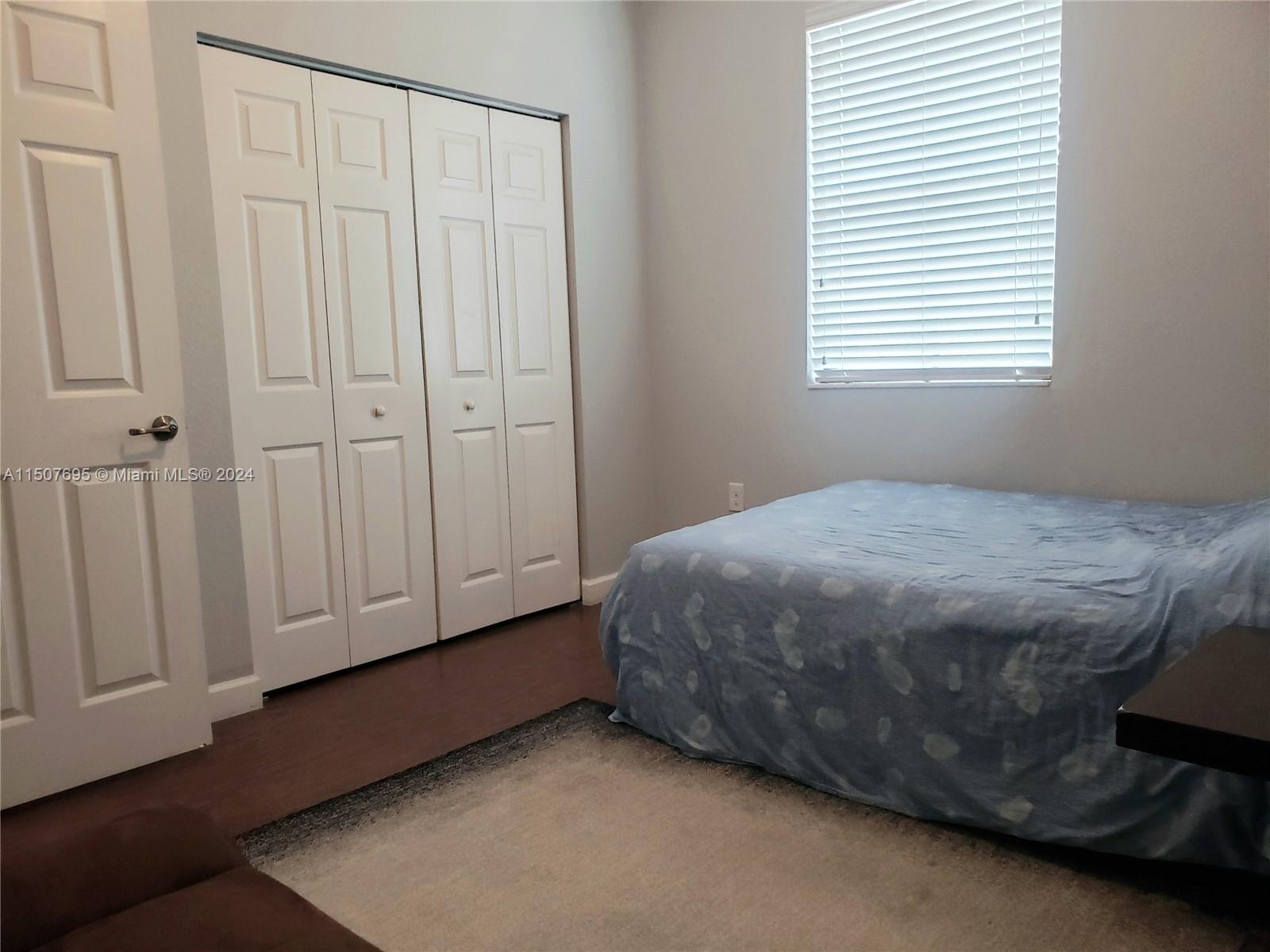 11343 Southwest 232nd Terrace Homestead, FL 33032 - Photo 23 of 35 a bedroom with a bed and a window