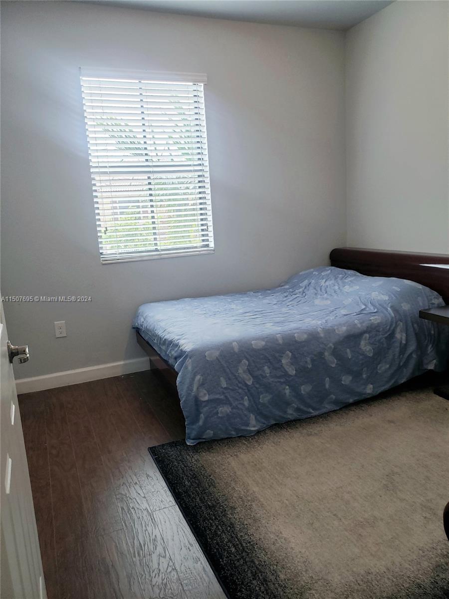 11343 Southwest 232nd Terrace Homestead, FL 33032 - Photo 24 of 35 a bedroom with a bed and a window