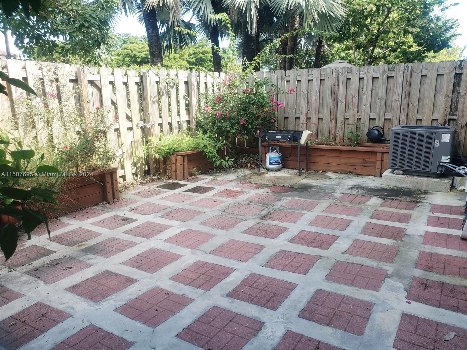 11343 Southwest 232nd Terrace Homestead, FL 33032 - Photo 29 of 35 a backyard of a house with chairs and a rug