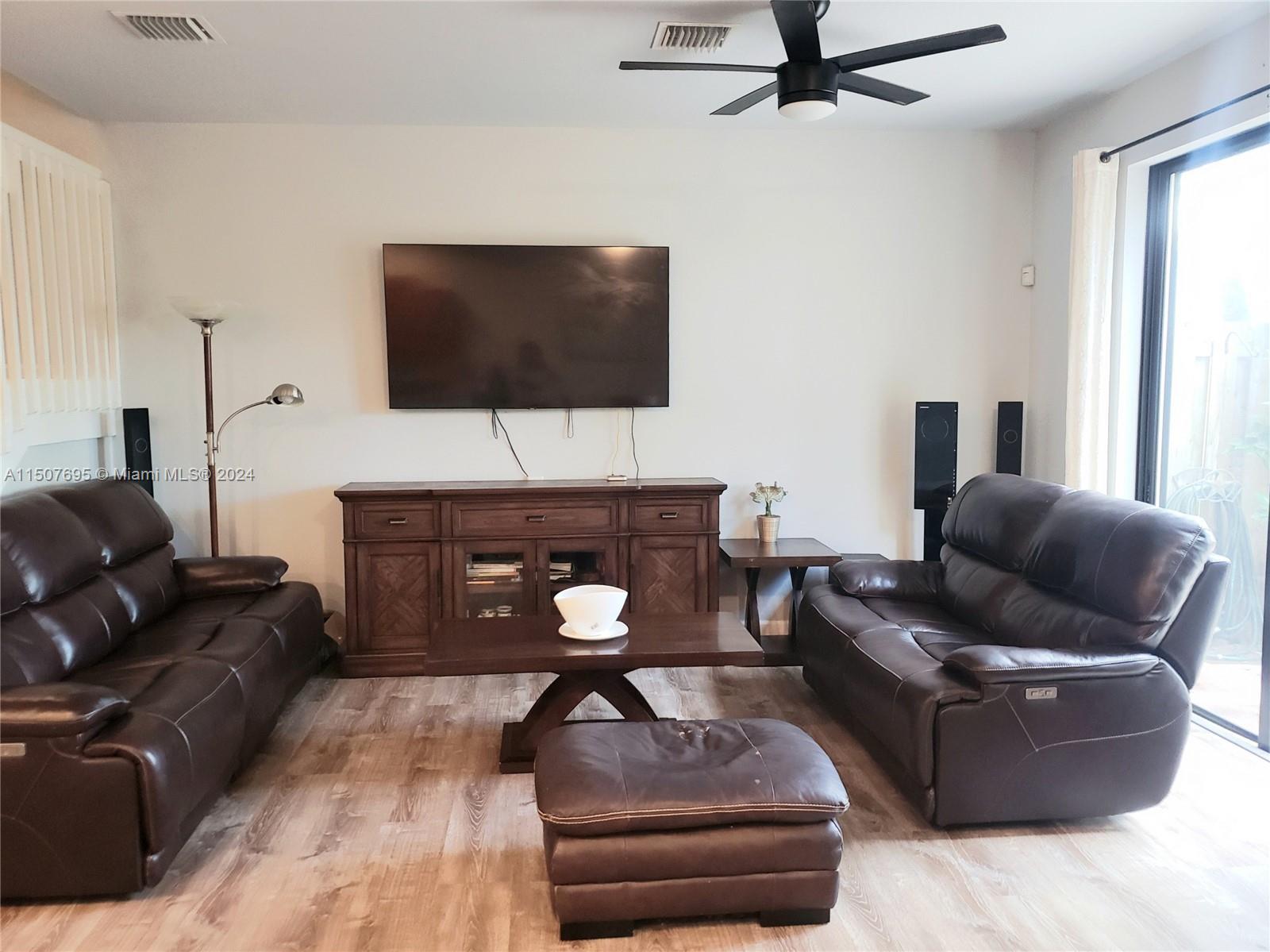11343 Southwest 232nd Terrace Homestead, FL 33032 - Photo 6 of 35 a living room with furniture and a flat screen tv