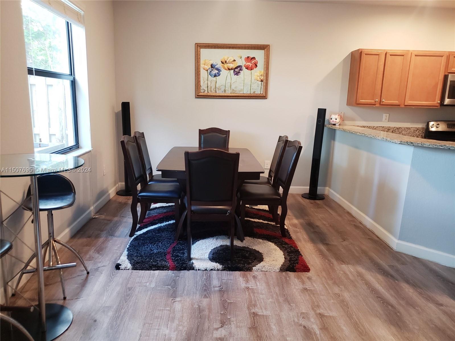 11343 Southwest 232nd Terrace Homestead, FL 33032 - Photo 7 of 35 a workspace with furniture and wooden floor