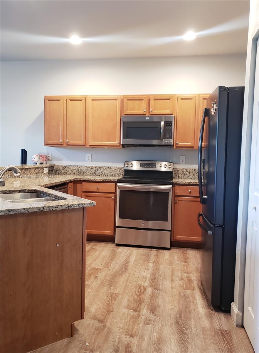 11343 Southwest 232nd Terrace Homestead, FL 33032 - Photo 9 of 35 a kitchen with stainless steel appliances granite countertop a stove a refrigerator and a sink