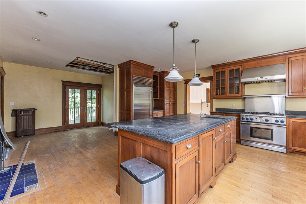 29 Gorham Street Chelmsford, MA 01824 - Photo 11 of 42 a kitchen with stainless steel appliances granite countertop a stove a sink and a refrigerator