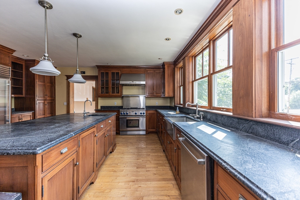 29 Gorham Street Chelmsford, MA 01824 - Photo 13 of 42 a kitchen with stainless steel appliances granite countertop counter space a sink and windows
